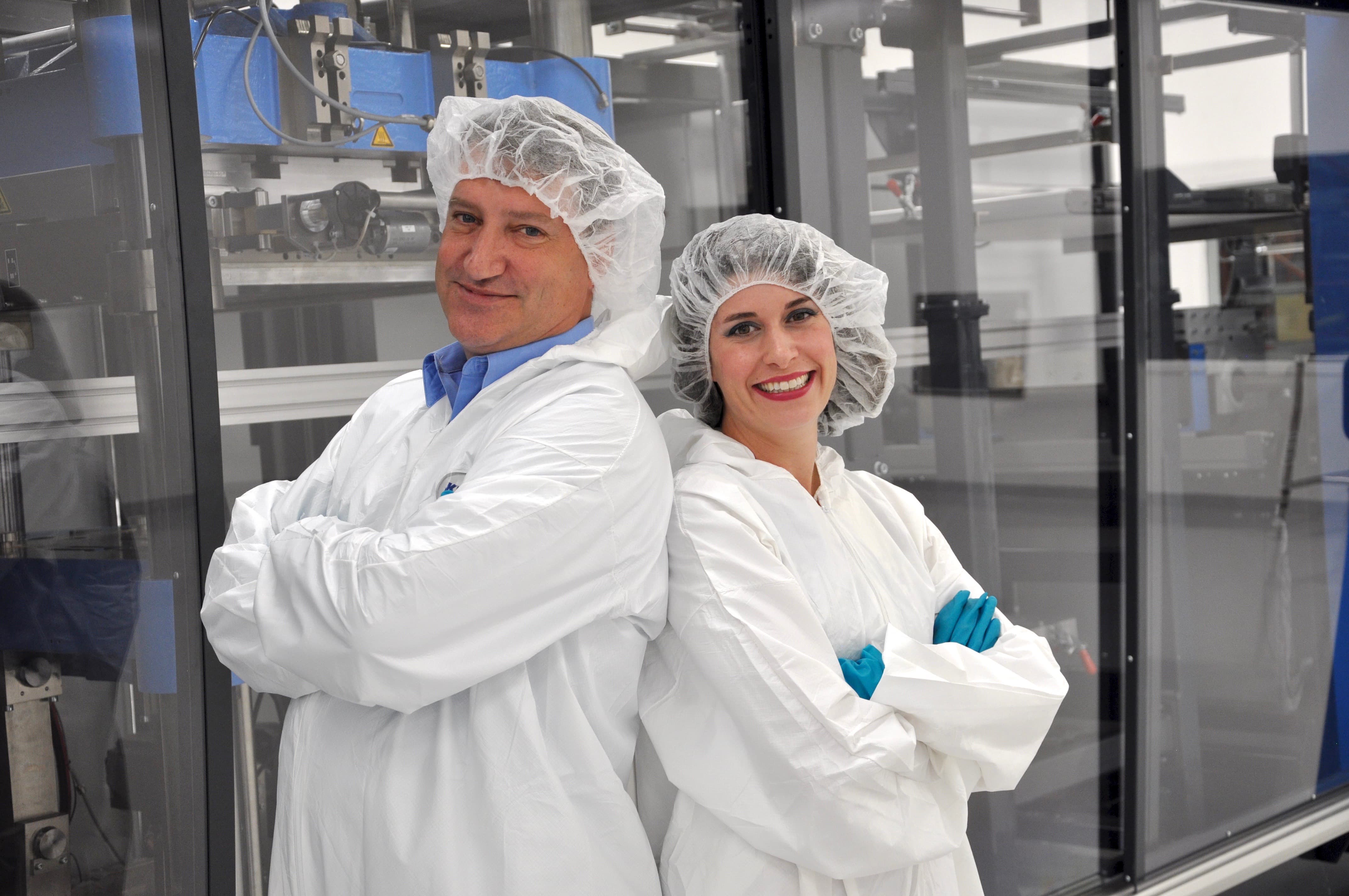 Second generation siblings in front of a medical thermoforming machine